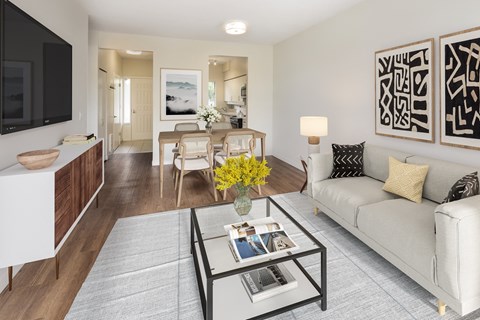 a living room with a couch and a glass coffee table